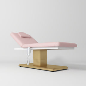 Manufakturo Chérie Premium Electric Massage Bed - Bare Blush - displayed in a professional treatment-room setting
