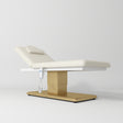 Manufakturo Chérie Premium Electric Massage Bed - Creamy - displayed in a professional treatment-room setting
