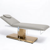 Manufakturo Chérie Pearl Greige electric massage bed — full product studio view with raised backrest and gold base.