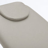 Manufakturo Chérie Pearl Greige electric massage bed — close-up of the removable headrest pillow and upholstery.