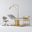 Manufakturo Chérie Pearl Greige four-piece salon set with electric massage bed, matching rolling beauty chair, V3 Pro Gold treatment lamp and empty three-tier gold trolley.