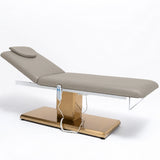 Manufakturo Chérie Stone Taupe electric massage bed — full product studio view with raised backrest and gold base.