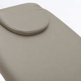 Manufakturo Chérie Stone Taupe electric massage bed — close-up of the removable headrest pillow and upholstery.