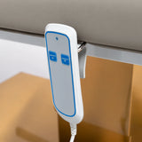 Manufakturo Chérie Stone Taupe electric massage bed — close-up of the two-button hand-held height control and upholstery.