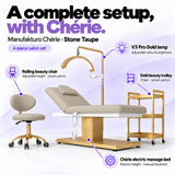 Manufakturo Chérie Stone Taupe salon set features: electric bed height and manual backrest adjustment, height-adjustable rolling chair, V3 Pro Gold lamp with adjustable colour and brightness, and three-tier gold trolley.