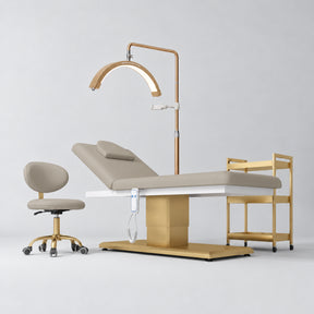 Manufakturo Chérie Stone Taupe four-piece salon set with electric massage bed, matching rolling beauty chair, V3 Pro Gold treatment lamp and empty three-tier gold trolley.