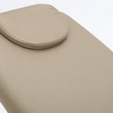 Manufakturo Chérie Warm Beige electric massage bed — close-up of the removable headrest pillow and upholstery.
