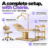 Manufakturo Chérie Warm Beige salon set features: electric bed height and manual backrest adjustment, height-adjustable rolling chair, V3 Pro Gold lamp with adjustable colour and brightness, and three-tier gold trolley.