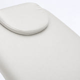 Manufakturo Chérie White electric massage bed — close-up of the removable headrest pillow and upholstery.