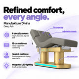 Manufakturo Divina electric spa treatment bed in Deep Ash, showing four electric motors, a 15 cm heated mattress, integrated LED lighting, face opening, adjustable armrests and twin-column base.