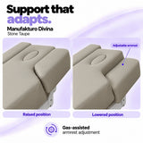 Manufakturo Divina Stone Taupe spa treatment bed armrests in raised and lowered positions, showing gas-assisted adjustment and both padded side supports.