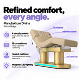 Manufakturo Divina electric spa treatment bed in Warm Beige, showing four electric motors, a 15 cm heated mattress, integrated LED lighting, face opening, adjustable armrests and twin-column base.