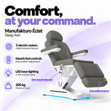 Manufakturo Éclat Deep Ash electric beauty bed with three electric motors, hand and foot controls, LED base lighting, 300 kg maximum load, one-touch descent, an extendable footrest and a solid one-piece headrest.