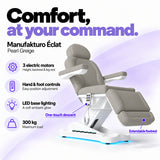Manufakturo Éclat Pearl Greige electric beauty bed with three electric motors, hand and foot controls, LED base lighting, 300 kg maximum load, one-touch descent, an extendable footrest and a solid one-piece headrest.