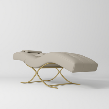 Manufakturo Elegance Lash Bed - Gold Frame & Adjustable Headrest Stone Taupe - displayed in a professional treatment-room setting