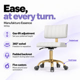 Manufakturo Essence White beauty chair with gas-lift height adjustment, 360-degree swivel, padded backrest and five castors on a gold base.