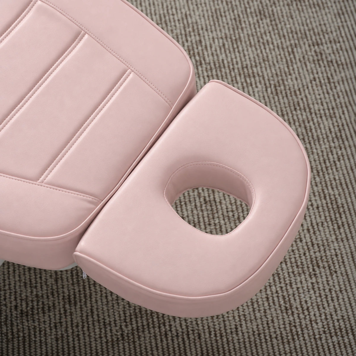 Manufakturo Grace Bare Blush electric beauty bed headrest detail, showing the open massage face hole and matching stitched upholstery.