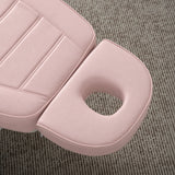 Manufakturo Grace Bare Blush electric beauty bed headrest detail, showing the open massage face hole and matching stitched upholstery.