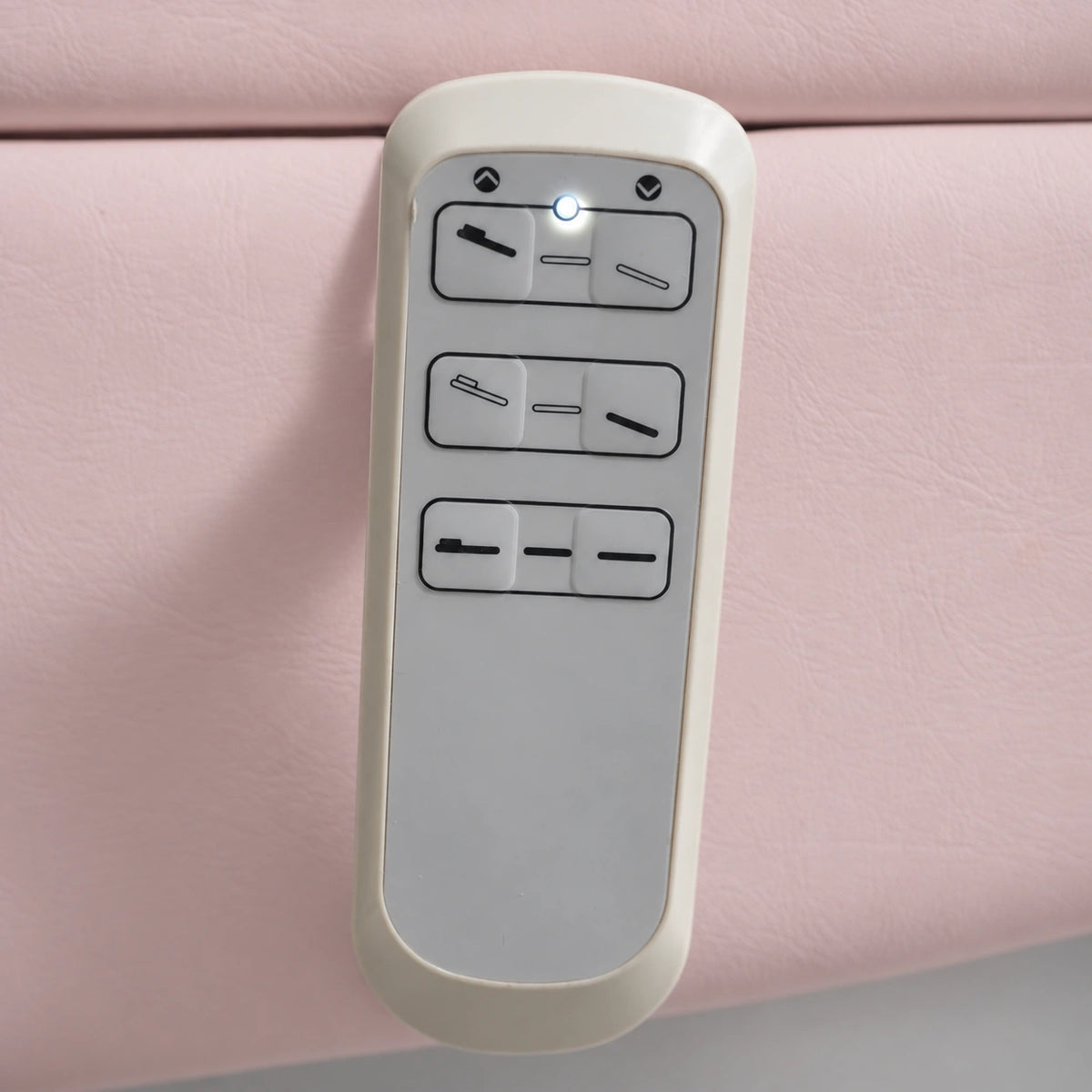 Manufakturo Grace Bare Blush electric beauty bed hand-held control with the original buttons and indicator, against matching upholstery.