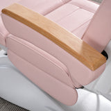 Manufakturo Grace Bare Blush electric beauty bed armrest detail, showing the natural wooden top and matching upholstered side cushions.
