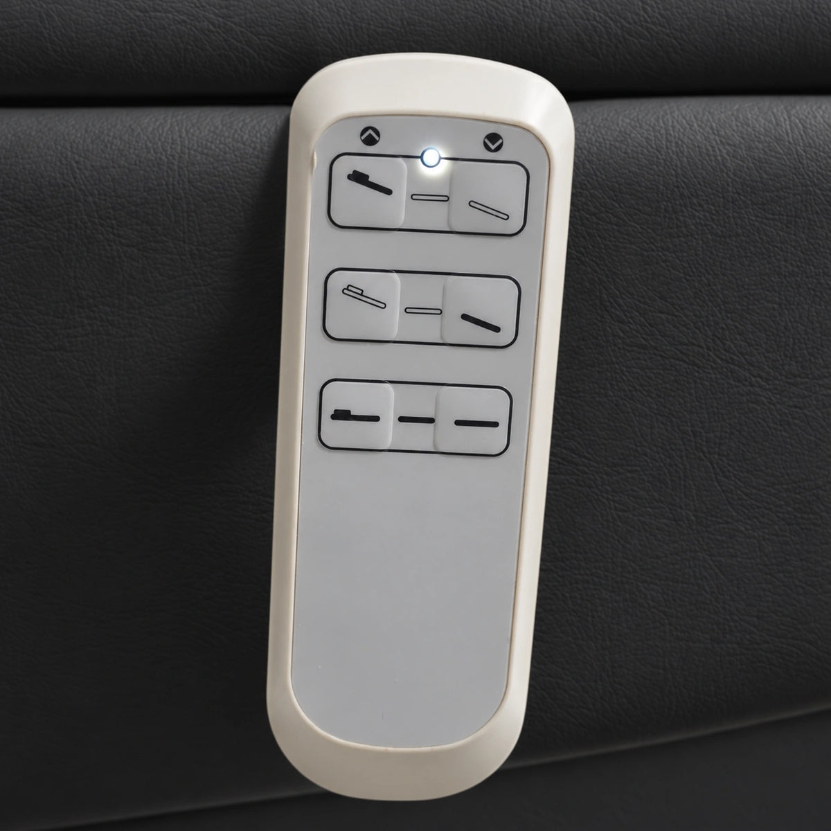 Manufakturo Grace Black electric beauty bed hand-held control with the original buttons and indicator, against matching upholstery.