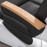 Manufakturo Grace Black electric beauty bed armrest detail, showing the natural wooden top and matching upholstered side cushions.