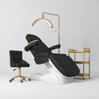 Manufakturo Grace Black complete salon set with electric beauty bed, Noblesse chair, V3 Pro Gold treatment lamp and three-tier gold trolley.