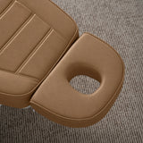 Manufakturo Grace Caramel electric beauty bed headrest detail, showing the open massage face hole and matching stitched upholstery.