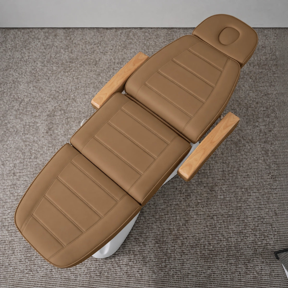 Manufakturo Grace Caramel electric beauty bed viewed from above, showing the segmented upholstery, face insert and wooden armrest caps.