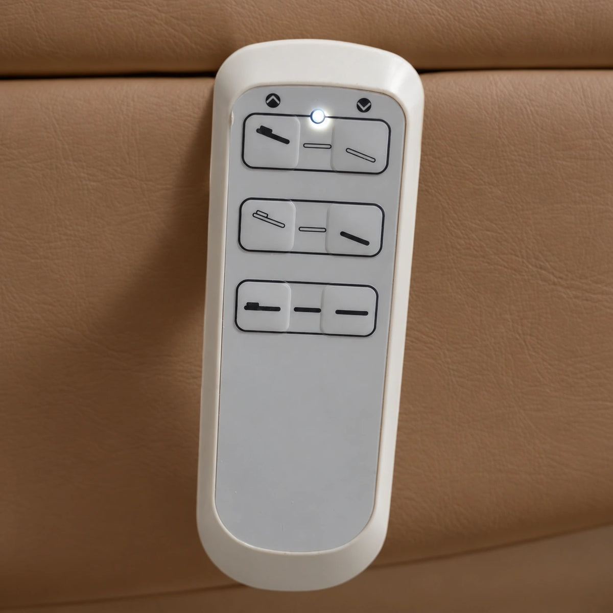 Manufakturo Grace Caramel electric beauty bed hand-held control with the original buttons and indicator, against matching upholstery.