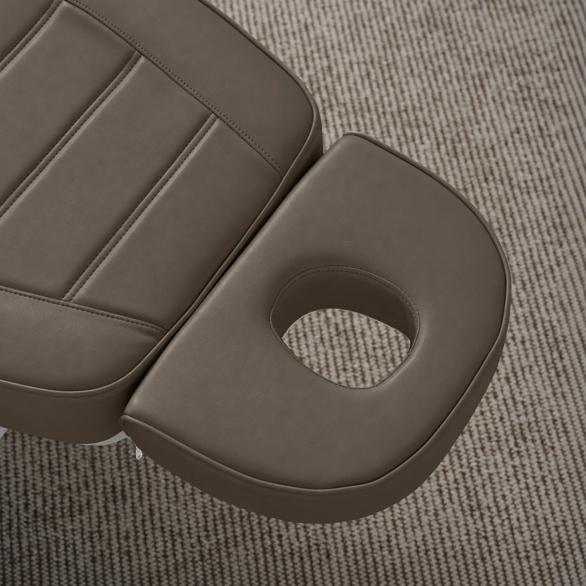 Manufakturo Grace Cocoa Mocha electric beauty bed headrest detail, showing the open massage face hole and matching stitched upholstery.