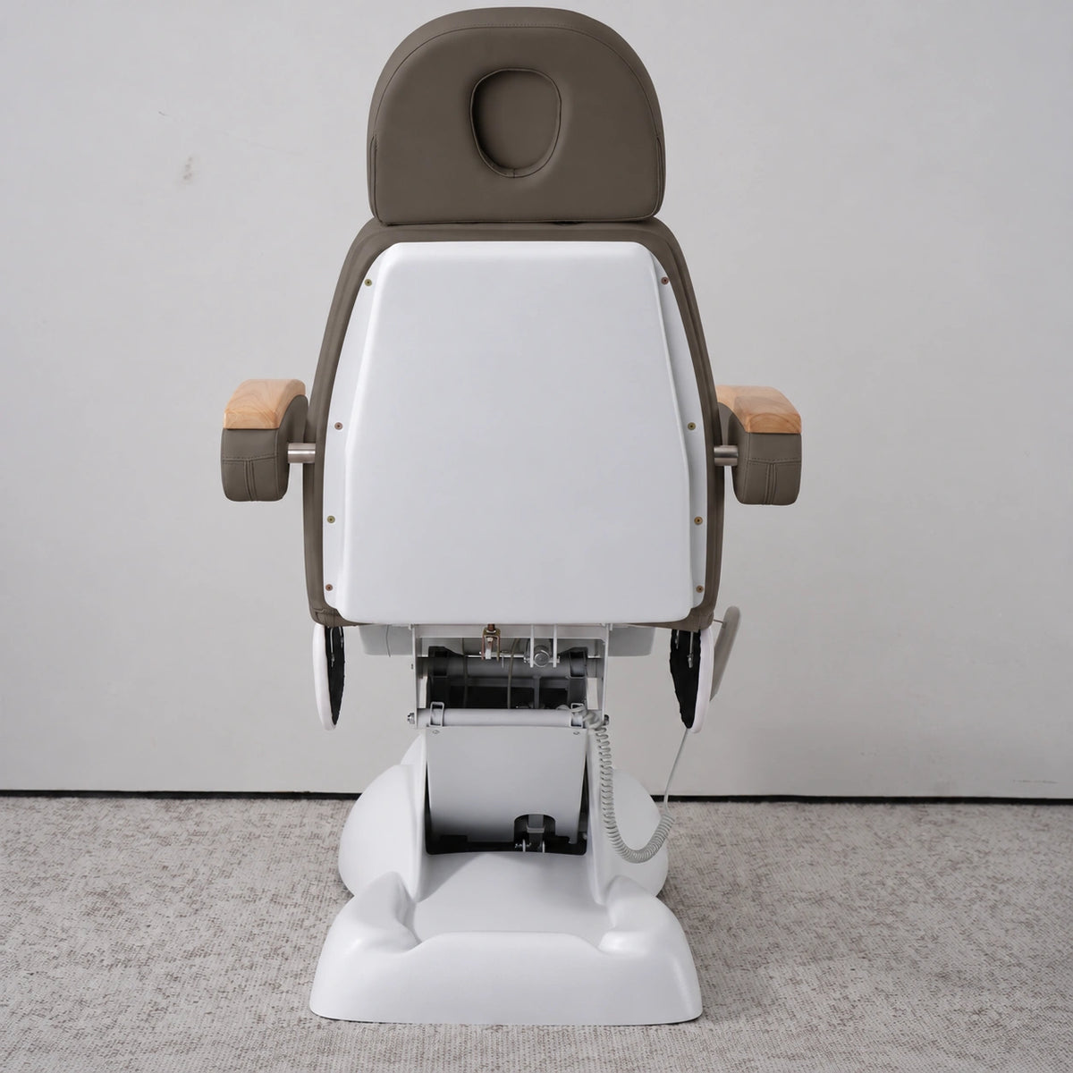 Rear view of the Manufakturo Grace Cocoa Mocha electric beauty bed, showing the upholstered headrest, white rigid rear cover and adjustment mechanism.