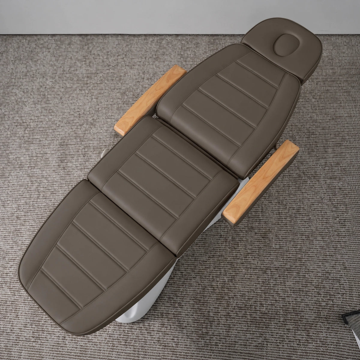 Manufakturo Grace Cocoa Mocha electric beauty bed viewed from above, showing the segmented upholstery, face insert and wooden armrest caps.