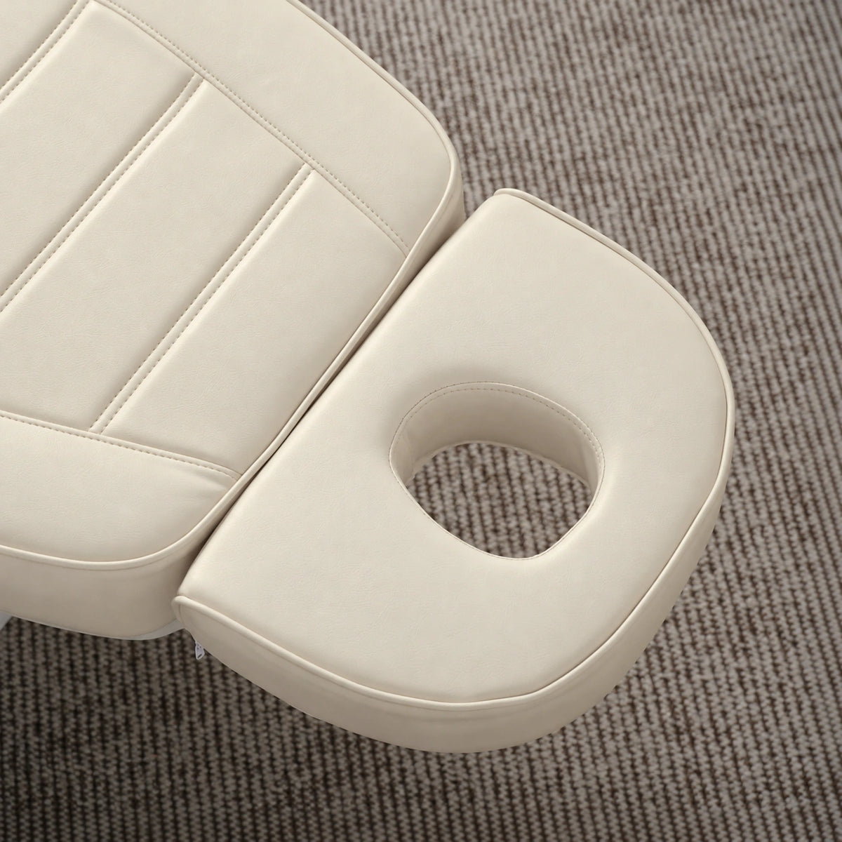 Manufakturo Grace Creamy electric beauty bed headrest detail, showing the open massage face hole and matching stitched upholstery.