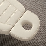 Manufakturo Grace Creamy electric beauty bed headrest detail, showing the open massage face hole and matching stitched upholstery.
