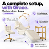 Manufakturo Grace Creamy four-piece salon set features: three-motor electric bed with hand-held control, Noblesse swivel chair, adjustable V3 Pro Gold lamp and three-tier gold trolley.