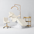 Manufakturo Grace Creamy complete salon set with electric beauty bed, Noblesse chair, V3 Pro Gold treatment lamp and three-tier gold trolley.