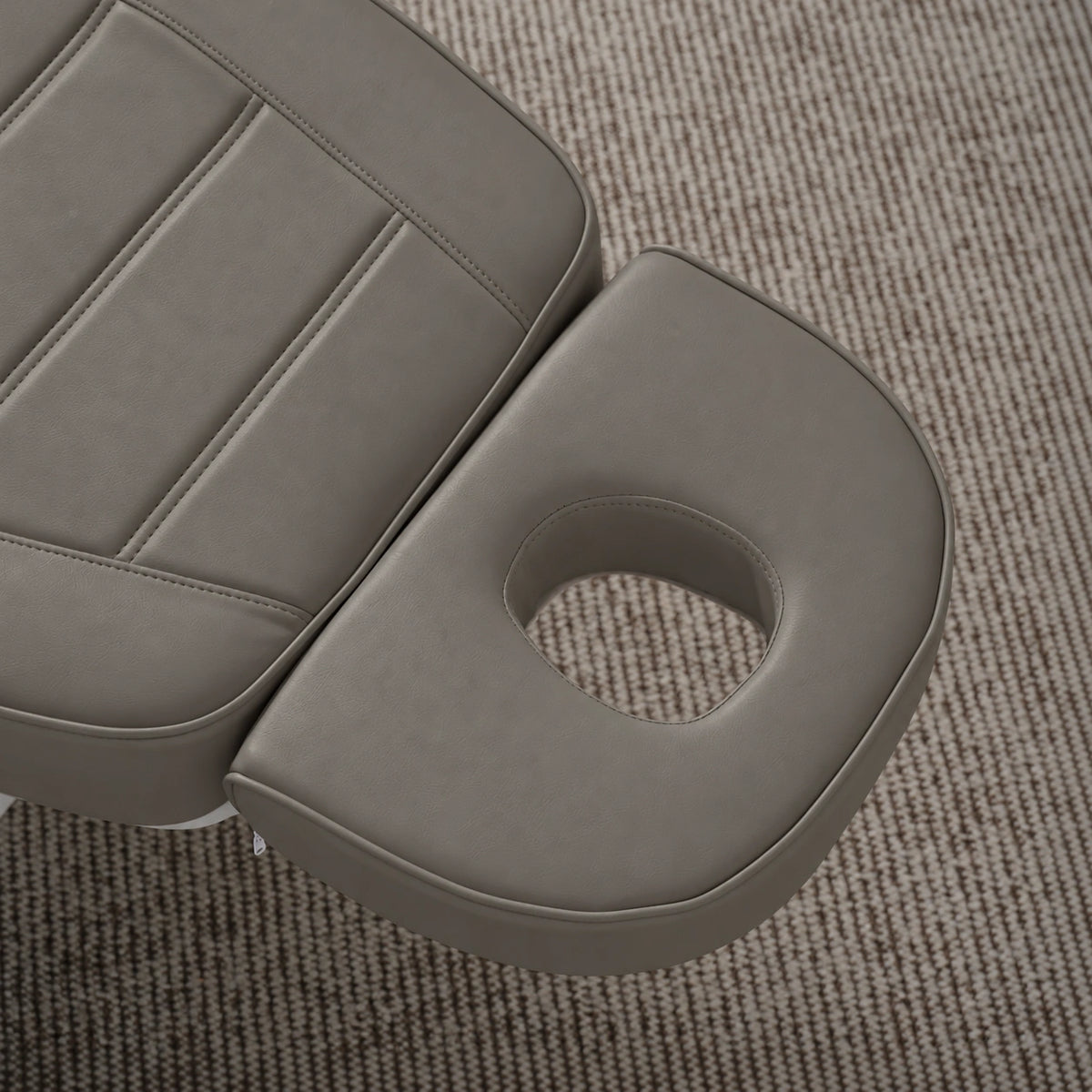 Manufakturo Grace Deep Ash electric beauty bed headrest detail, showing the open massage face hole and matching stitched upholstery.