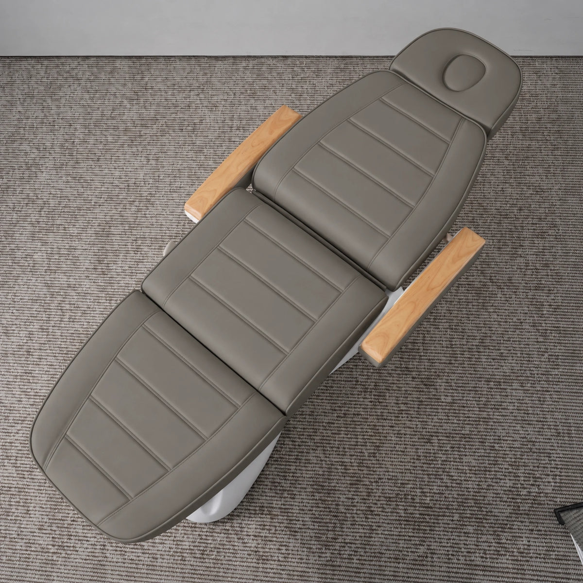 Manufakturo Grace Deep Ash electric beauty bed viewed from above, showing the segmented upholstery, face insert and wooden armrest caps.