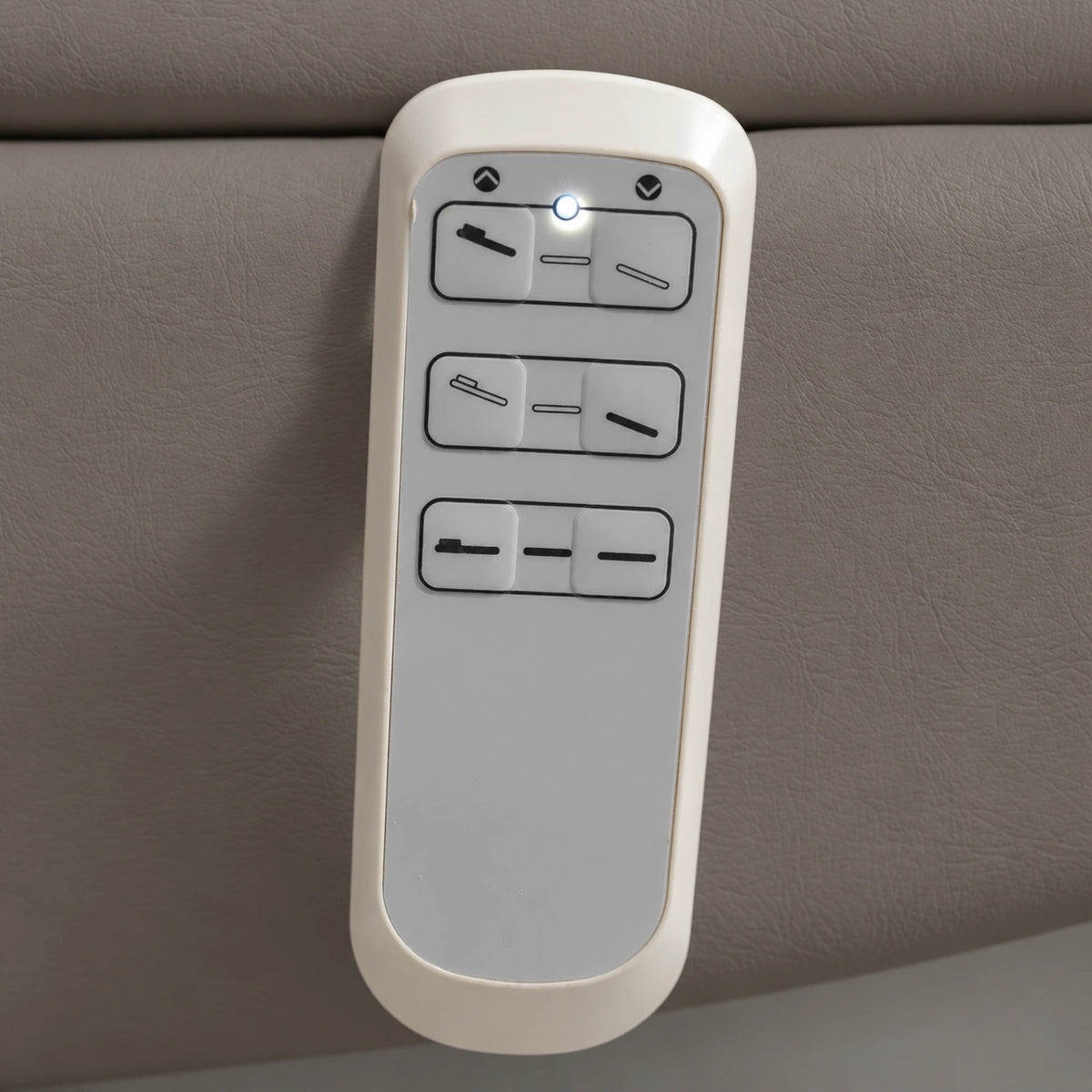 Manufakturo Grace Deep Ash electric beauty bed hand-held control with the original buttons and indicator, against matching upholstery.