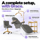 Manufakturo Grace Deep Ash four-piece salon set features: three-motor electric bed with hand-held control, Noblesse swivel chair, adjustable V3 Pro Gold lamp and three-tier gold trolley.