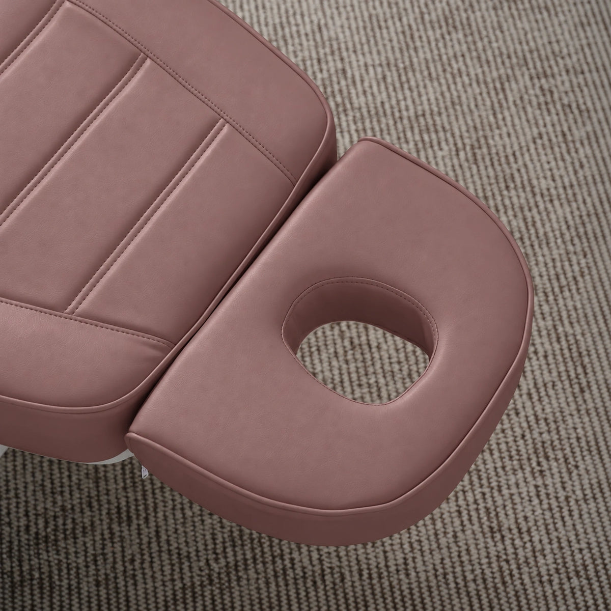 Manufakturo Grace Dusty Rose electric beauty bed headrest detail, showing the open massage face hole and matching stitched upholstery.