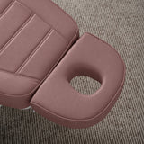 Manufakturo Grace Dusty Rose electric beauty bed headrest detail, showing the open massage face hole and matching stitched upholstery.