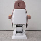 Rear view of the Manufakturo Grace Dusty Rose electric beauty bed, showing the upholstered headrest, white rigid rear cover and adjustment mechanism.