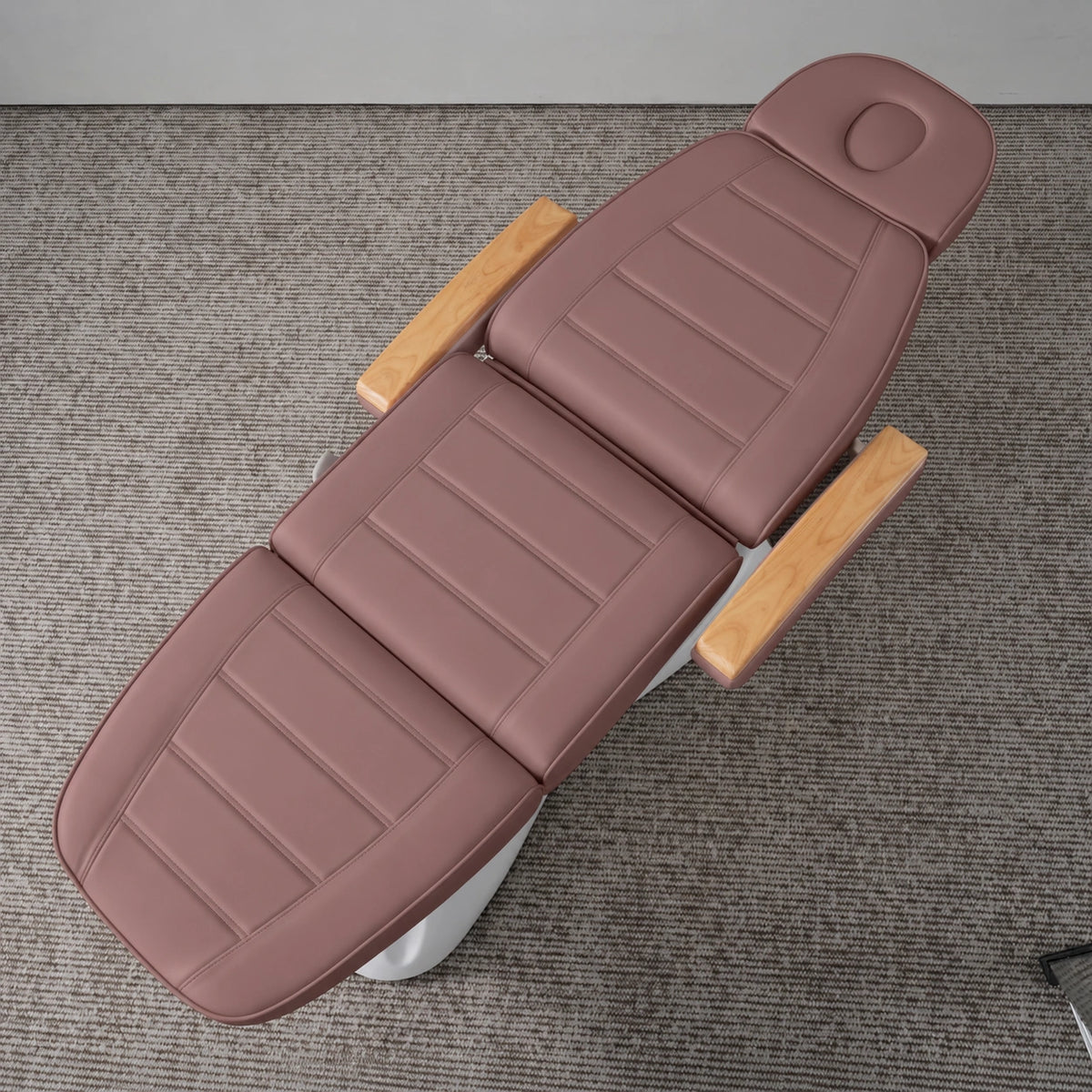 Manufakturo Grace Dusty Rose electric beauty bed viewed from above, showing the segmented upholstery, face insert and wooden armrest caps.