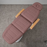 Manufakturo Grace Dusty Rose electric beauty bed viewed from above, showing the segmented upholstery, face insert and wooden armrest caps.