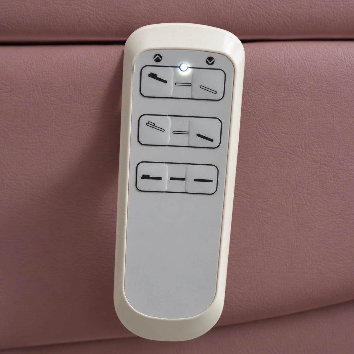 Manufakturo Grace Dusty Rose electric beauty bed hand-held control with the original buttons and indicator, against matching upholstery.
