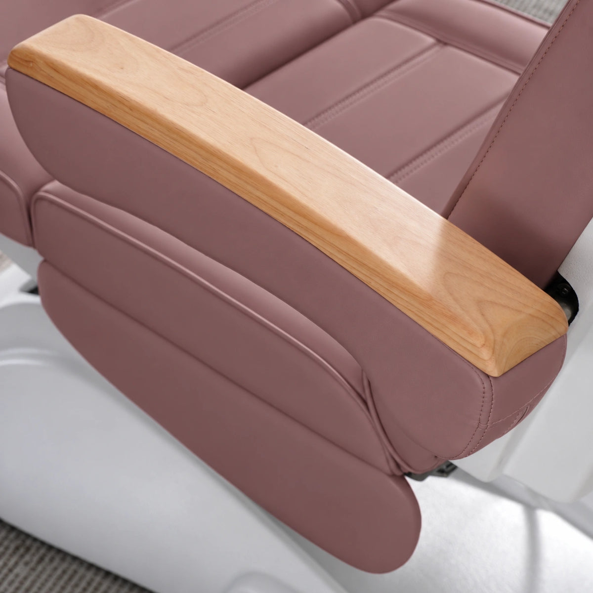 Manufakturo Grace Dusty Rose electric beauty bed armrest detail, showing the natural wooden top and matching upholstered side cushions.