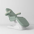 Manufakturo Grace Electric Beauty Bed - 3 Motors Olive - displayed in a professional treatment-room setting