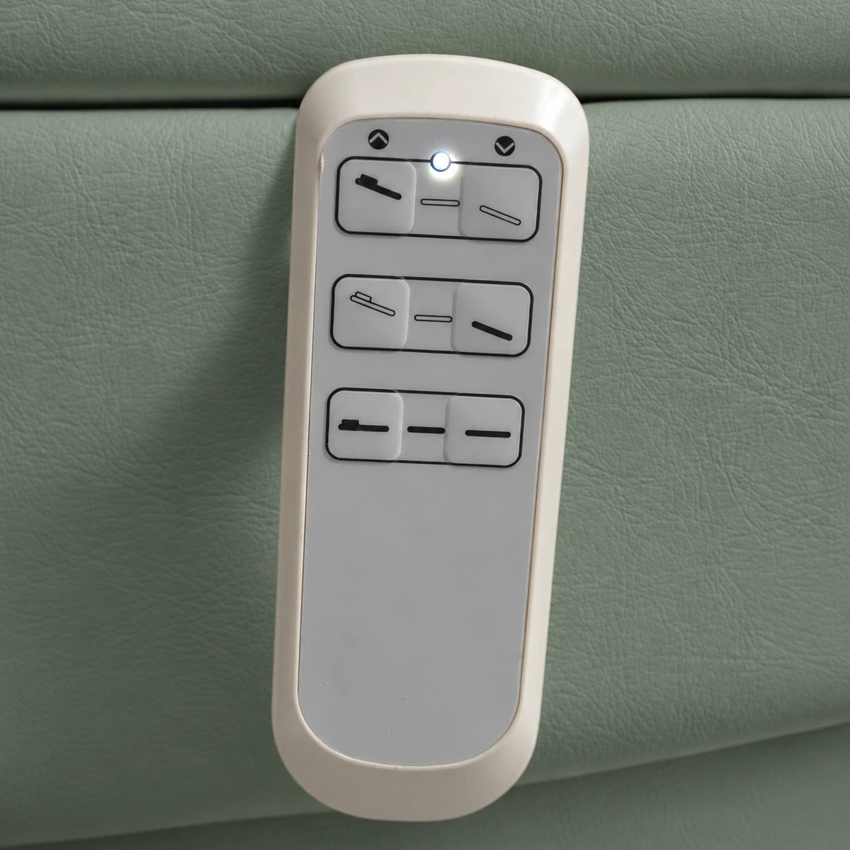Manufakturo Grace Olive electric beauty bed hand-held control with the original buttons and indicator, against matching upholstery.